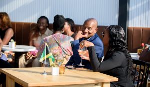 Couple posing at the Jamaica Canadian Association of New Brunswick event in Moncton, NB, with the man looking at the camera. Event photography services available in Saint John, Fredericton, and surrounding areas.